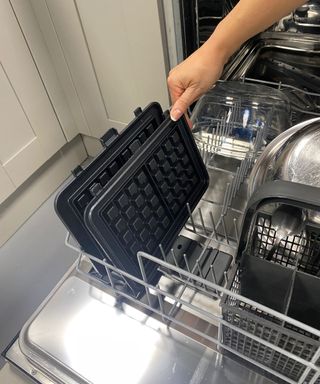 Christina Chrysostomou putting Cuisinart waffle iron plates in the dishwasher