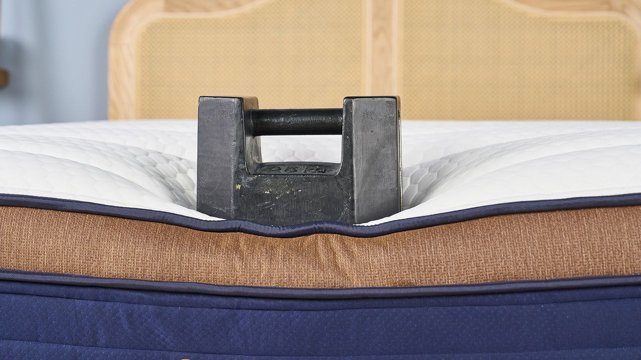 A weight placed on the edge of the Brooklyn Bedding CopperFlex Pro mattress