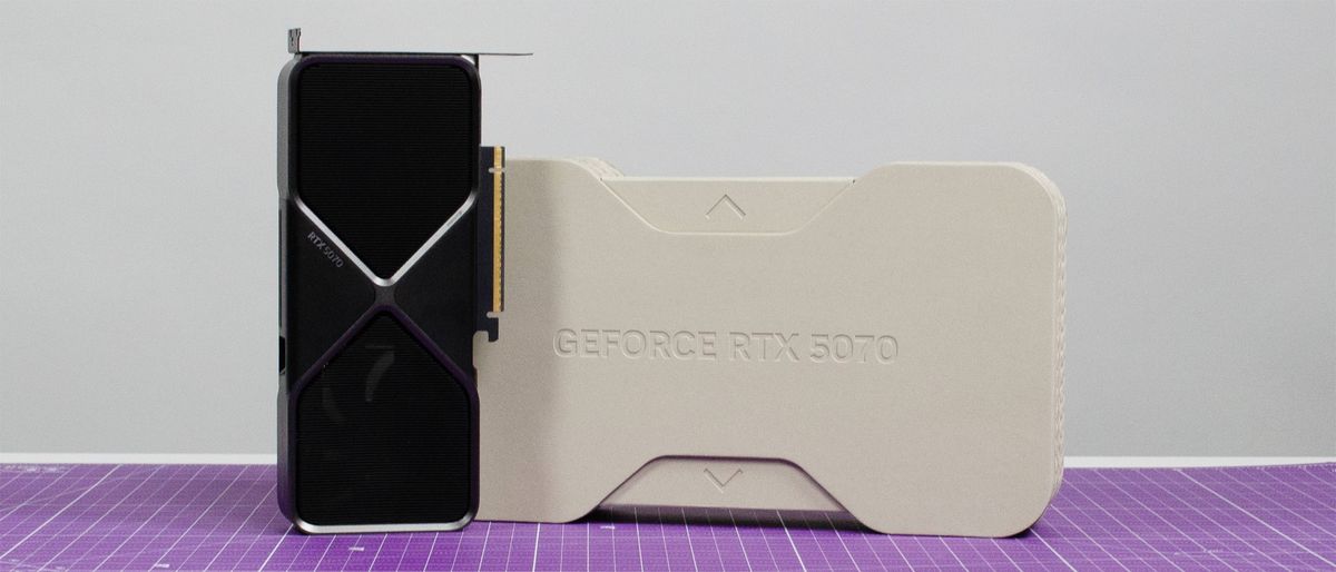 An Nvidia GeForce RTX 5070 on a table next to its retail packaging