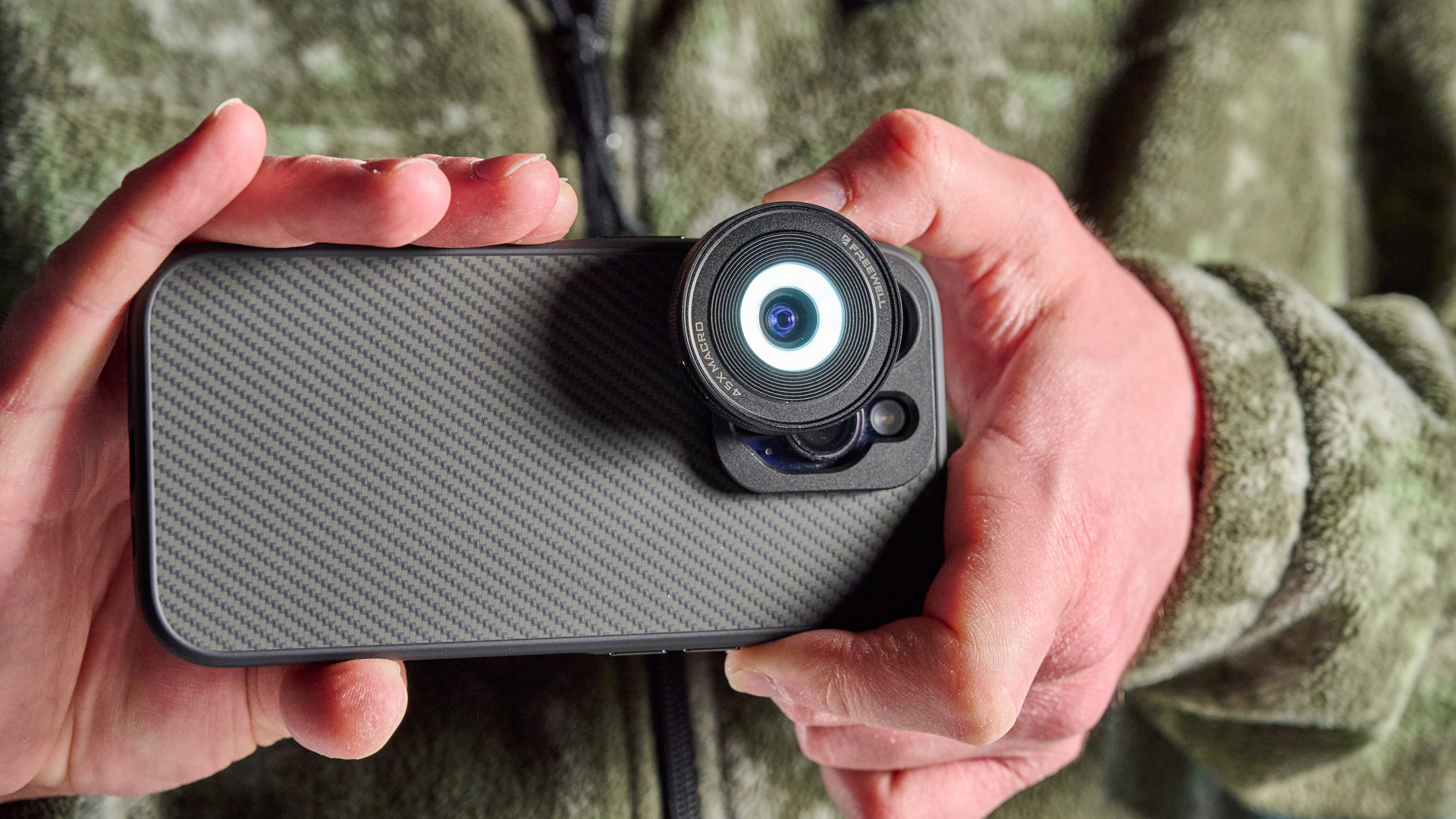 The Freewell iPhone lens on a phone in hand