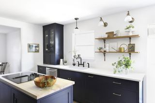 monochrome kitchen with black cabinets and white walls with open shelves