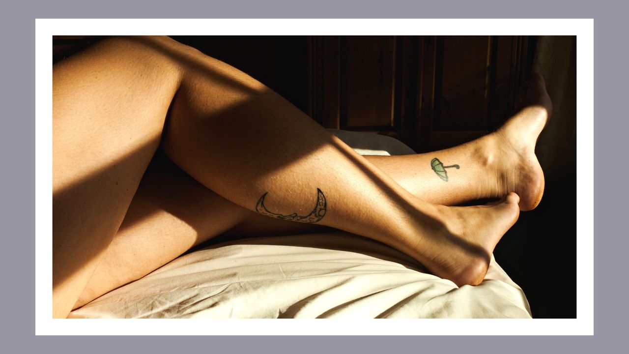 A young woman&#039;s legs on a bed in sunlight