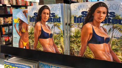 A magazine rack with copies of Sports Illustrated