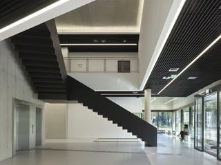 Black staircase in concrete atrium
