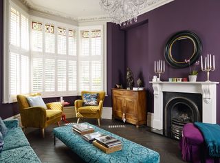 living room with velvet furniture, jewel colours and white shutters