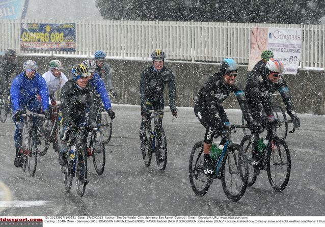 Riders search for their team buses after the race was neutralised