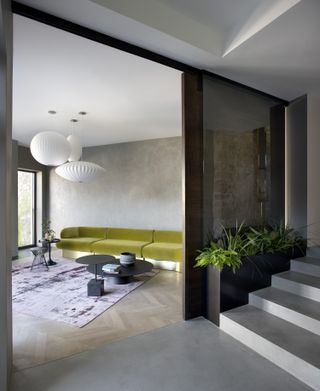A minimalist living room with mustard sofa and purple rug