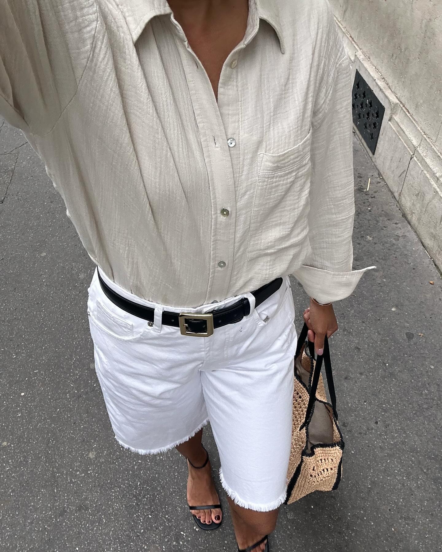 Woman wearing long denim bermuda short.