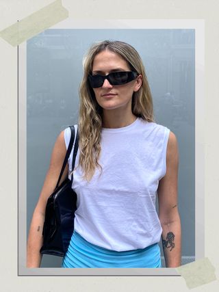 A fashion editor wearing the Prada Propionate Wrap Sunglasses.