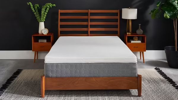 The Tempur-Pedic Tempur Topper Supreme mattress topper placed on a grey mattress that&#039;s sat on a wooden bed frame