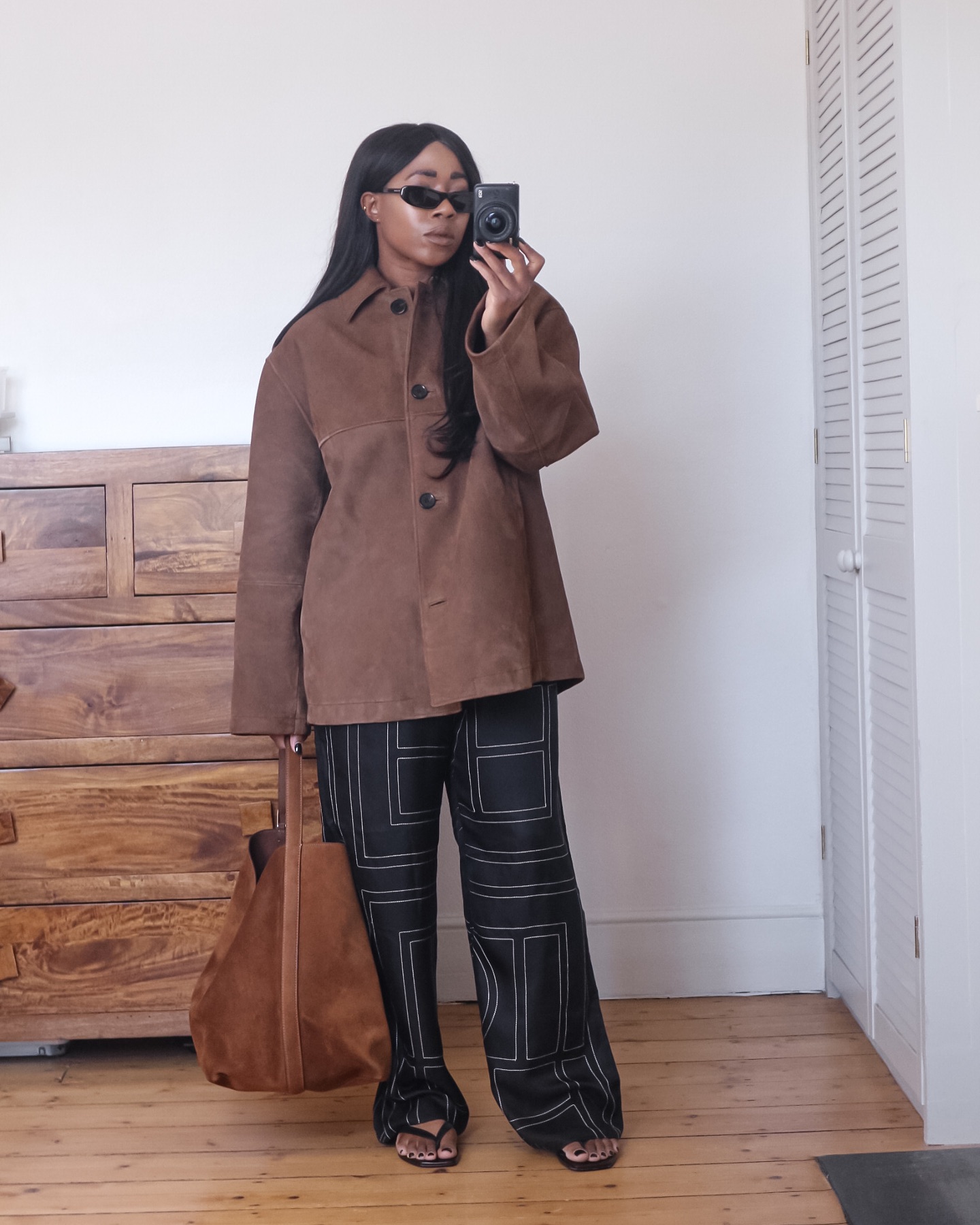 Stylish women wearing black and brown outfits