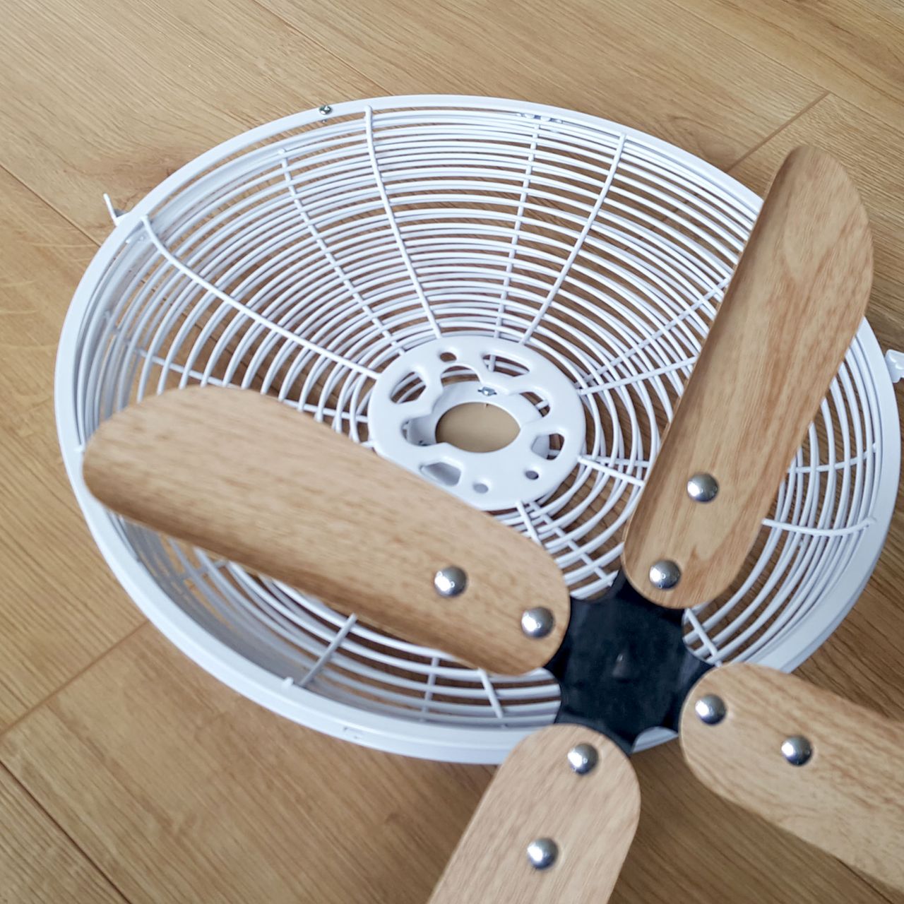 The Russell Hobbs 12&rdquo; Scandi Desk Fan being assembled on a wooden floor