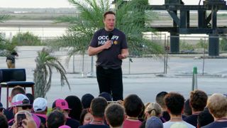 Elon Musk discusses Coverage Above and Beyond, a collaboration between SpaceX and T-Mobile that aims to boost cellphone connectivity by using SpaceX Starlink satellites, during a presentation at SpaceX's Starbase facility in Texas on Aug. 25, 2022.