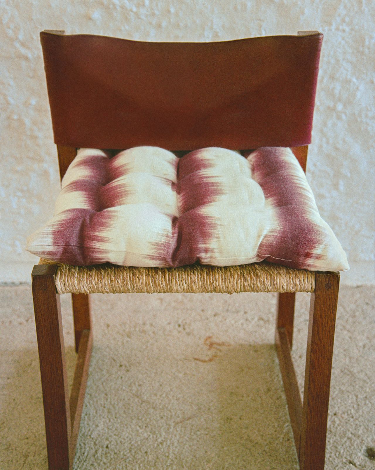 wooden chair with a woven seat and Ikat cushion