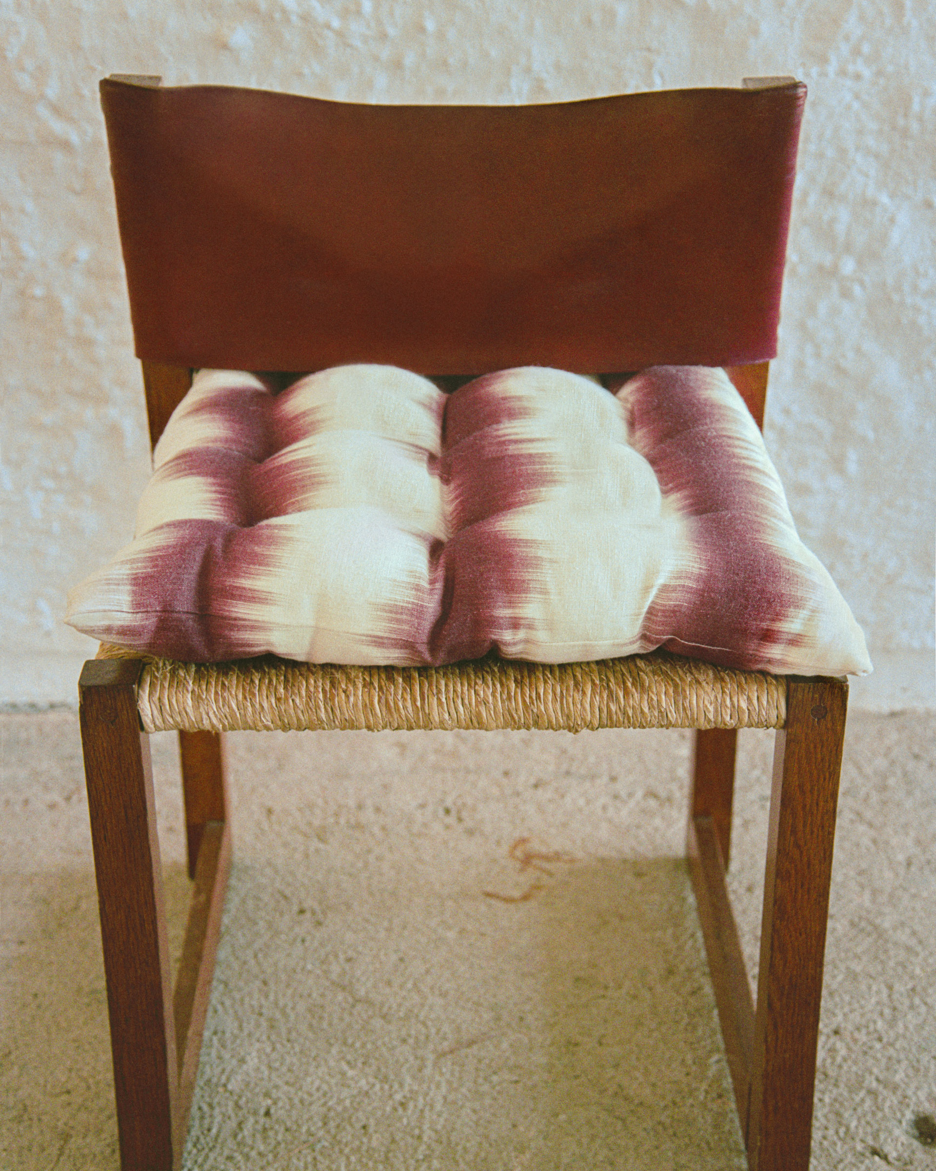 wooden chair with a woven seat and Ikat cushion