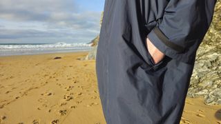 Finisterre Tego changing robe at the beach being worn by model