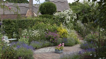 how to plan a cottage garden a garden with paved pathways