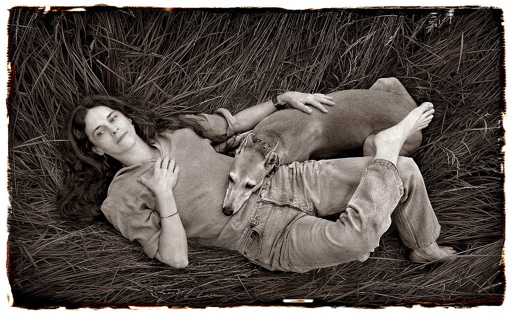 A sepia toned photograph of Sally Mann with her dog on her farm in Lexington, from 2004