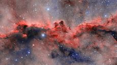 an image of a nebula with a red horizontal cloud that resembles two dragons