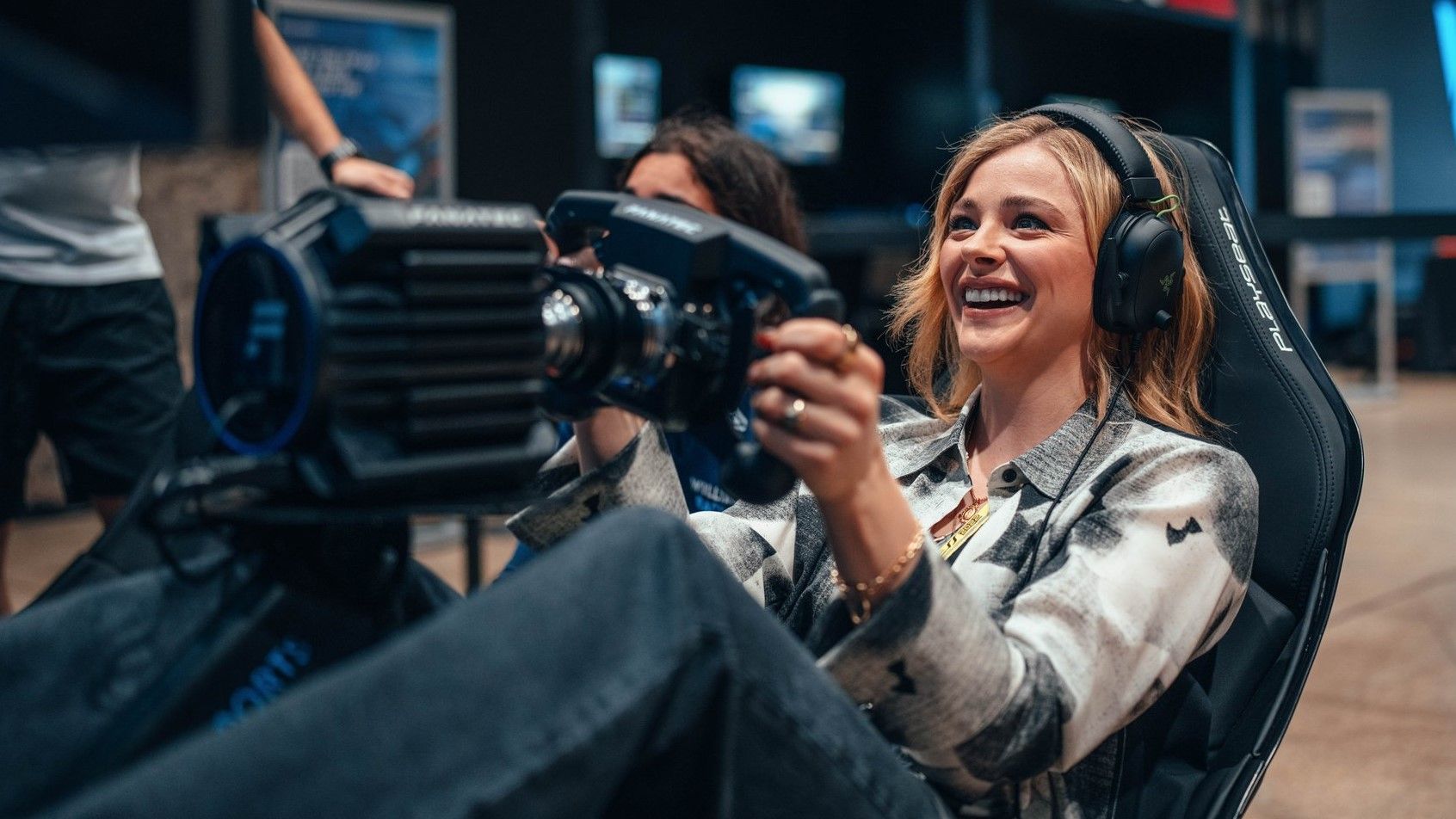 Chloe Moretz playing a sim racing game 