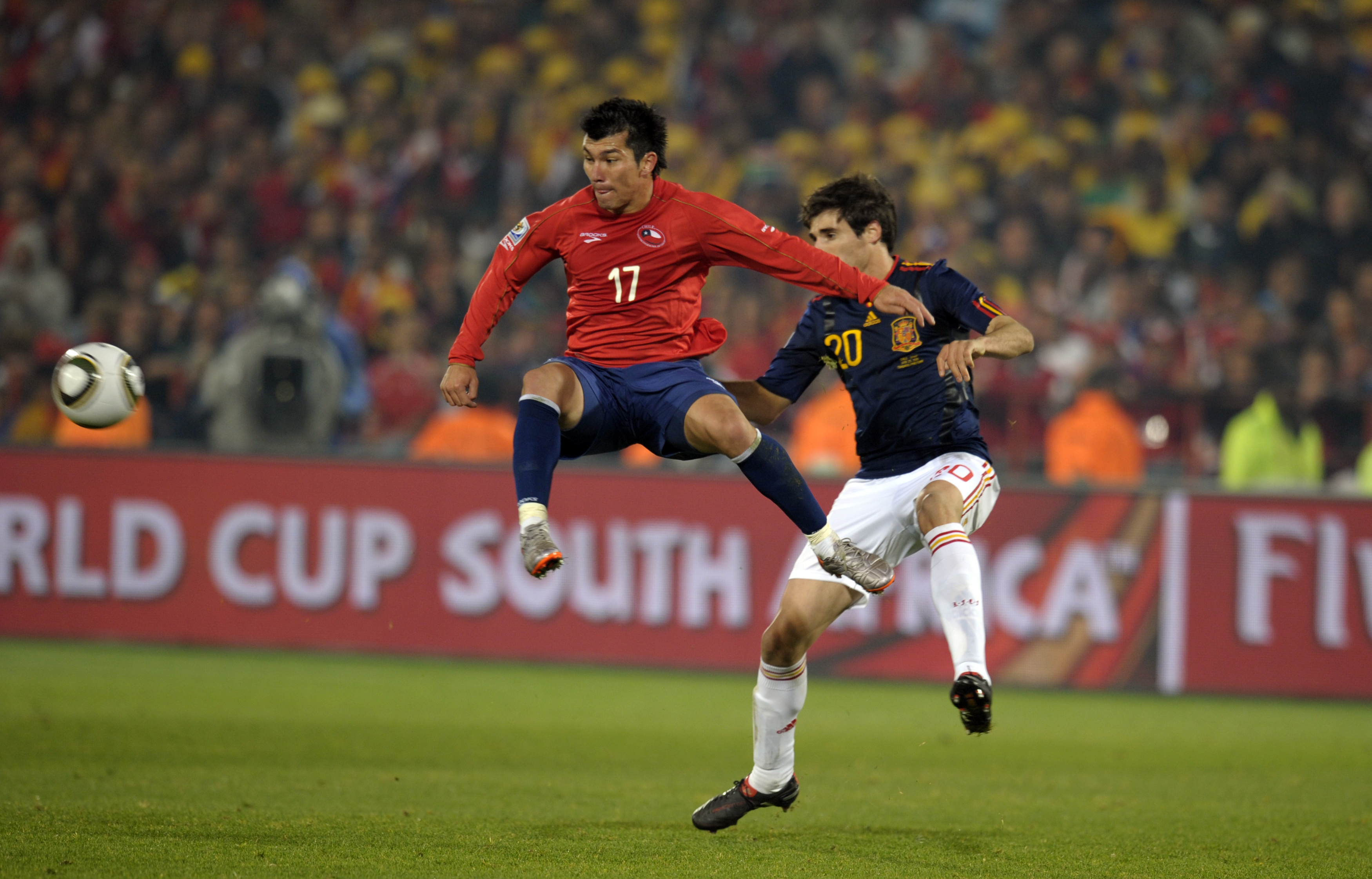 Spain's Javi Martinez (right) competes for the ball with Chile's Gary Medel at the 2010 World Cup.