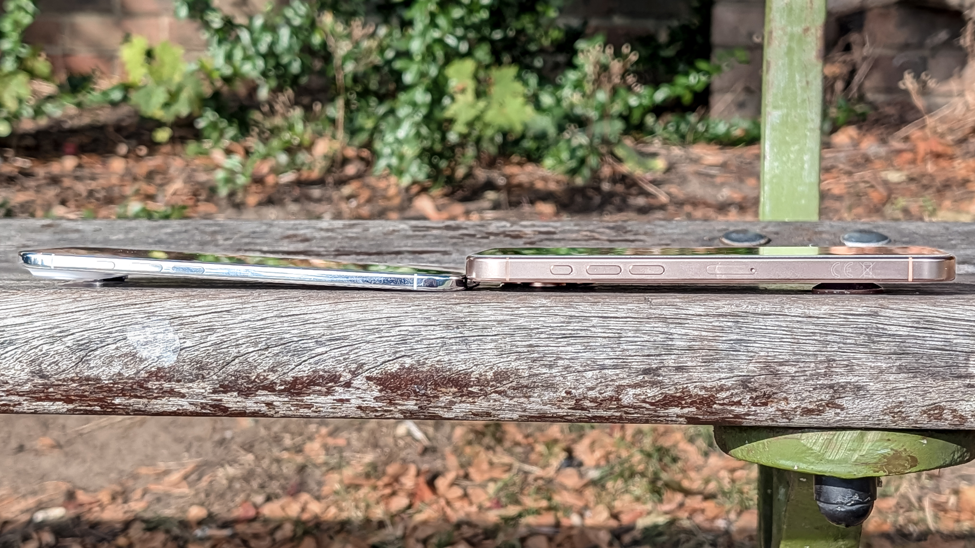 The iPhone Air and iPhone 16 Pro Max on a bench, showing relative thicknesses