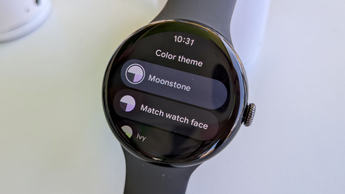 The Color theme settings screen on Wear OS 6 on the Pixel Watch 3, showing the primary "Match watch face" view and some set theme options like Moonstone and Ivy.