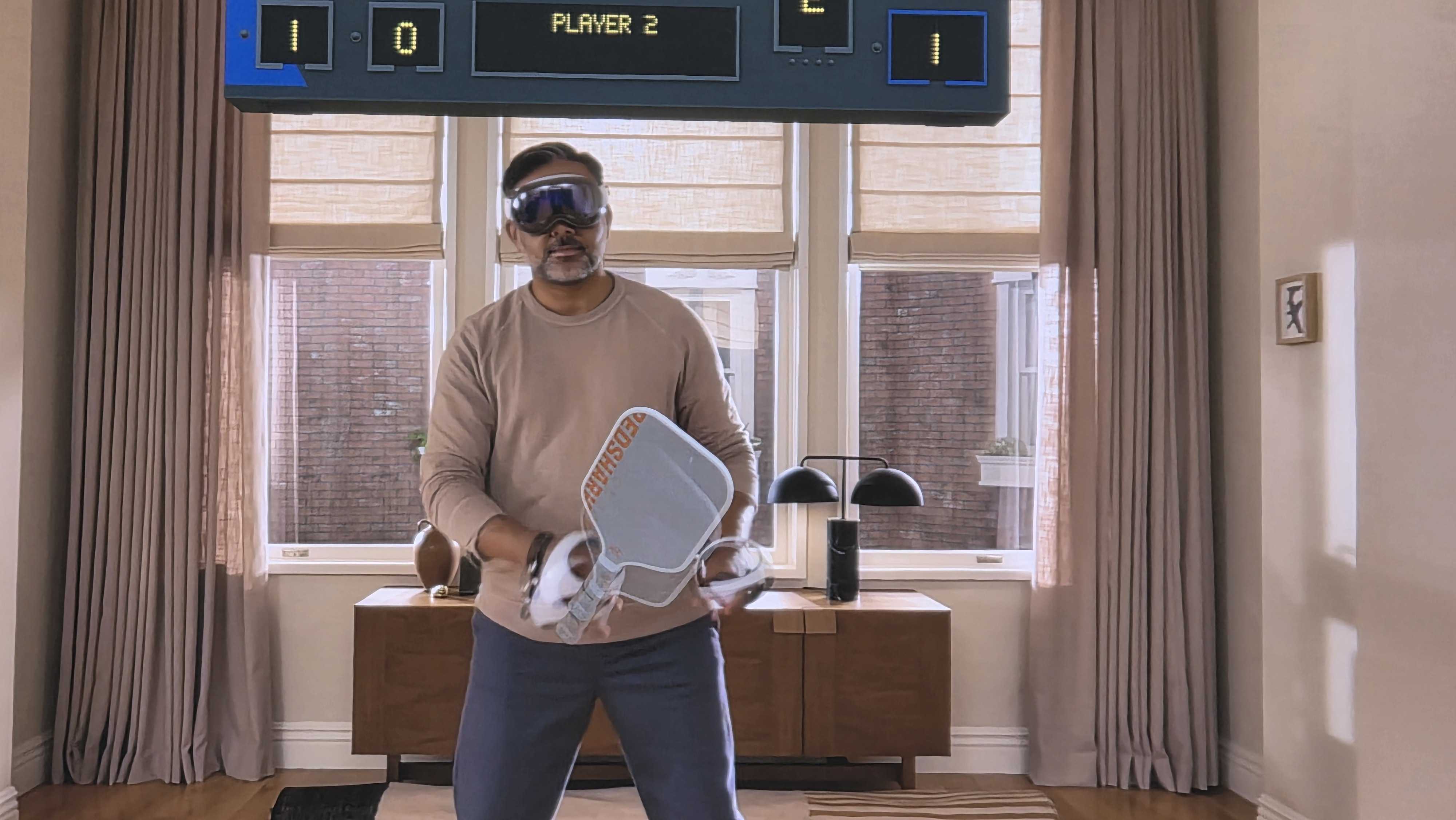 An Apple Vision Pro user with Sony Playstation VR controllers