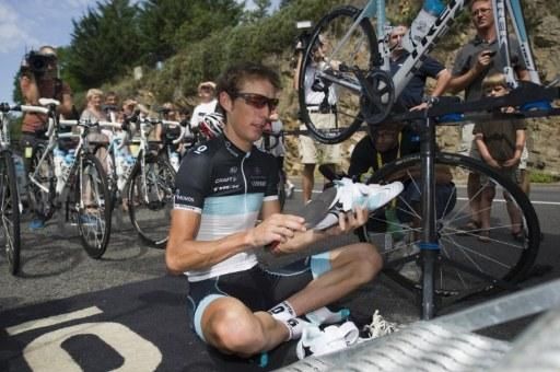 Luxembourg's Andy Schleck looks like he's meditating as he checks his pair of shoes prior to a training session in Anglards de Saint-Flour.