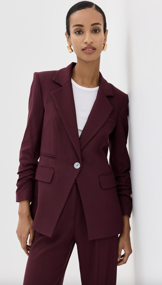 a model wearing a burgundy blazer