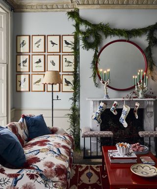 Christmas wall decor ideas with a foliage garland strung around a fireplace area