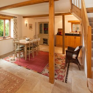 kitchen area with stairwall and exposed beams and wooden cabinetry