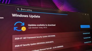 A photo of a gaming monitor displaying queued Windows updates