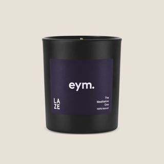 Eym Laze Candle against a beige background. 