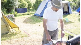 Man cooking at camp