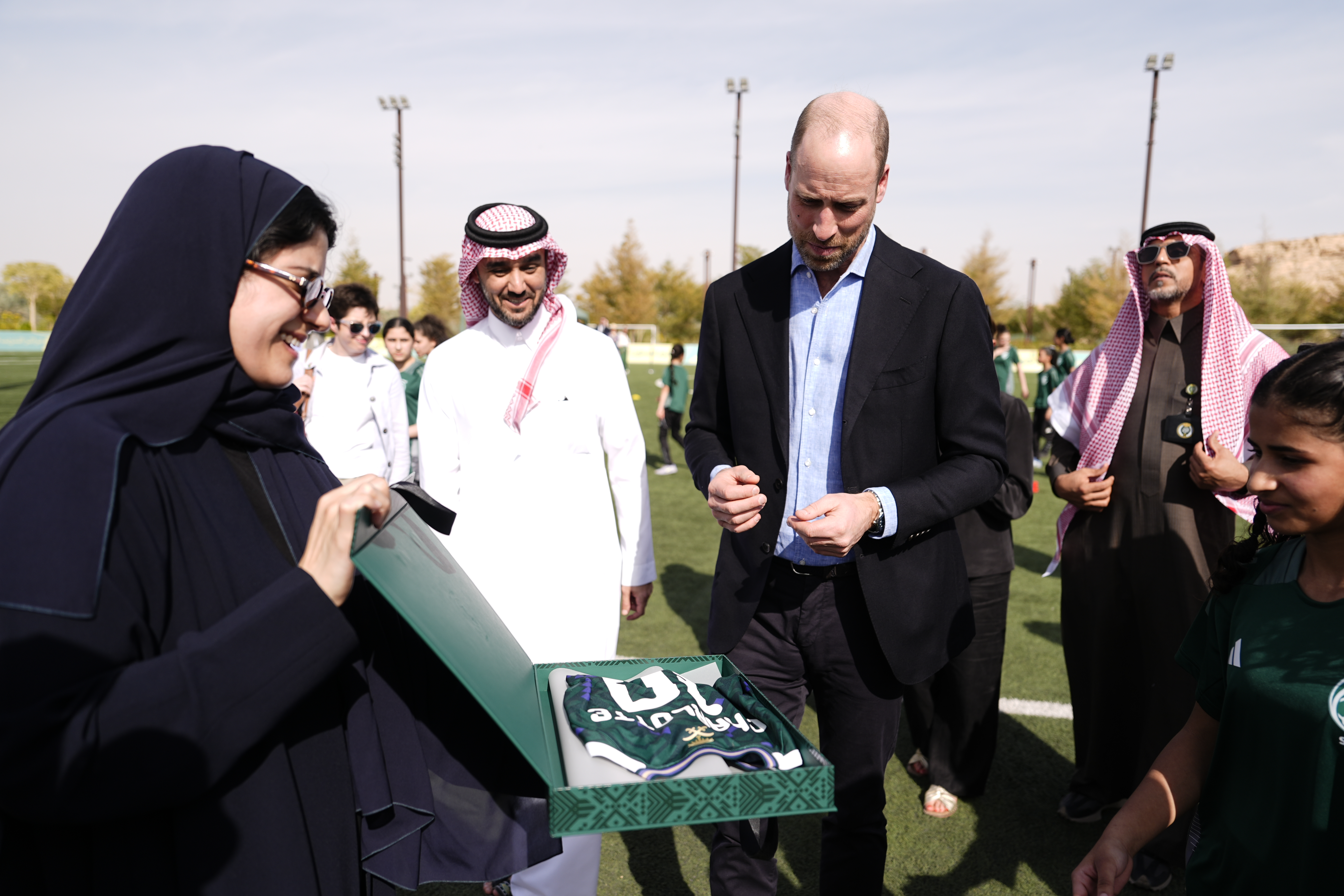 Prince William, Prince of Wales is presented with a football shirt during a visit to MISK Sports City in Riyadh to learn about the increasing role of women in society and particular their growing participation in sport, on day two of his first official visit to Saudi Arabia at MISK Sports City on February 10, 2026 in Riyadh, Saudi Arabia.