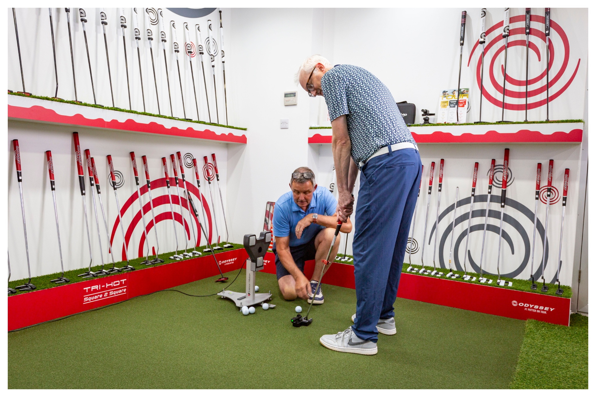 A male golfer being fitted for an Odyssey putter