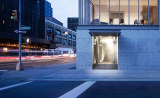 Glass box interlocked on an exposed concrete base creating the stability and transition from the dynamic urban fabric into a calm private residence