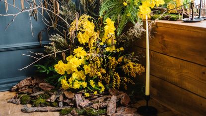 Spring candle display with yellow flowers