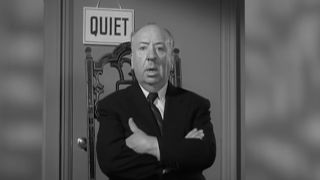 Alfred Hitchcock in front of Quiet sign in Alfred Hitchcock Presents