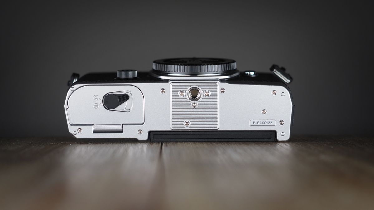 OM System OM-3 on a wooden surface