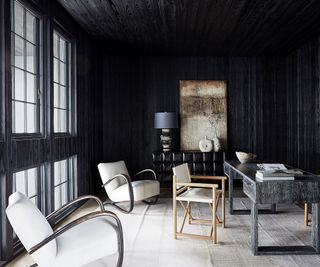 home office with white armchairs and dark walls