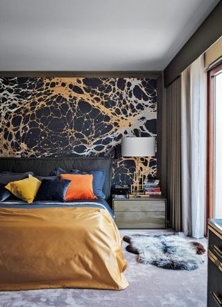Modern bedroom with black and orange mural