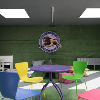 green walled common room with multi-coloured furniture