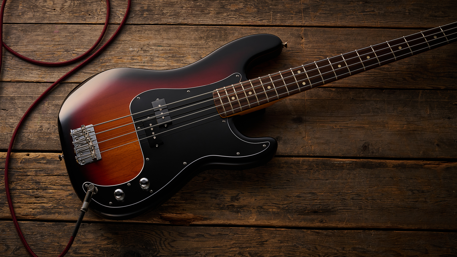 Fender American Professional Classic Precision Bass in 3-Color Sunburst shot on wood floor boards
