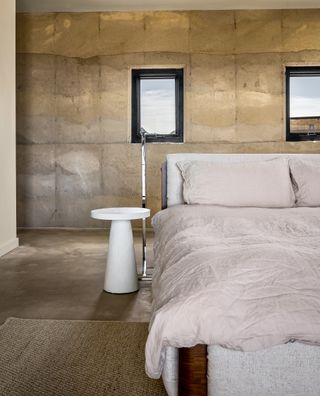 morning dove, a new house at twentynine palms by homestead modern, showing rammed earth walls, rough and contemporary volumes and windows out to desert landscape views