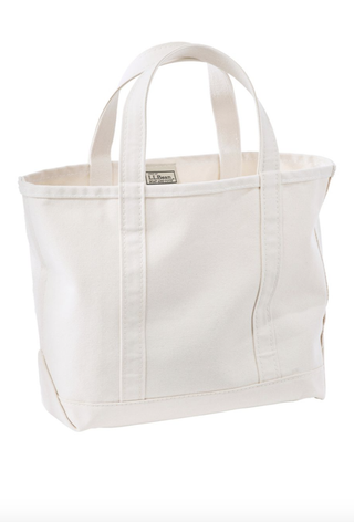 a canvas llbean tote in front of a plain backdrop