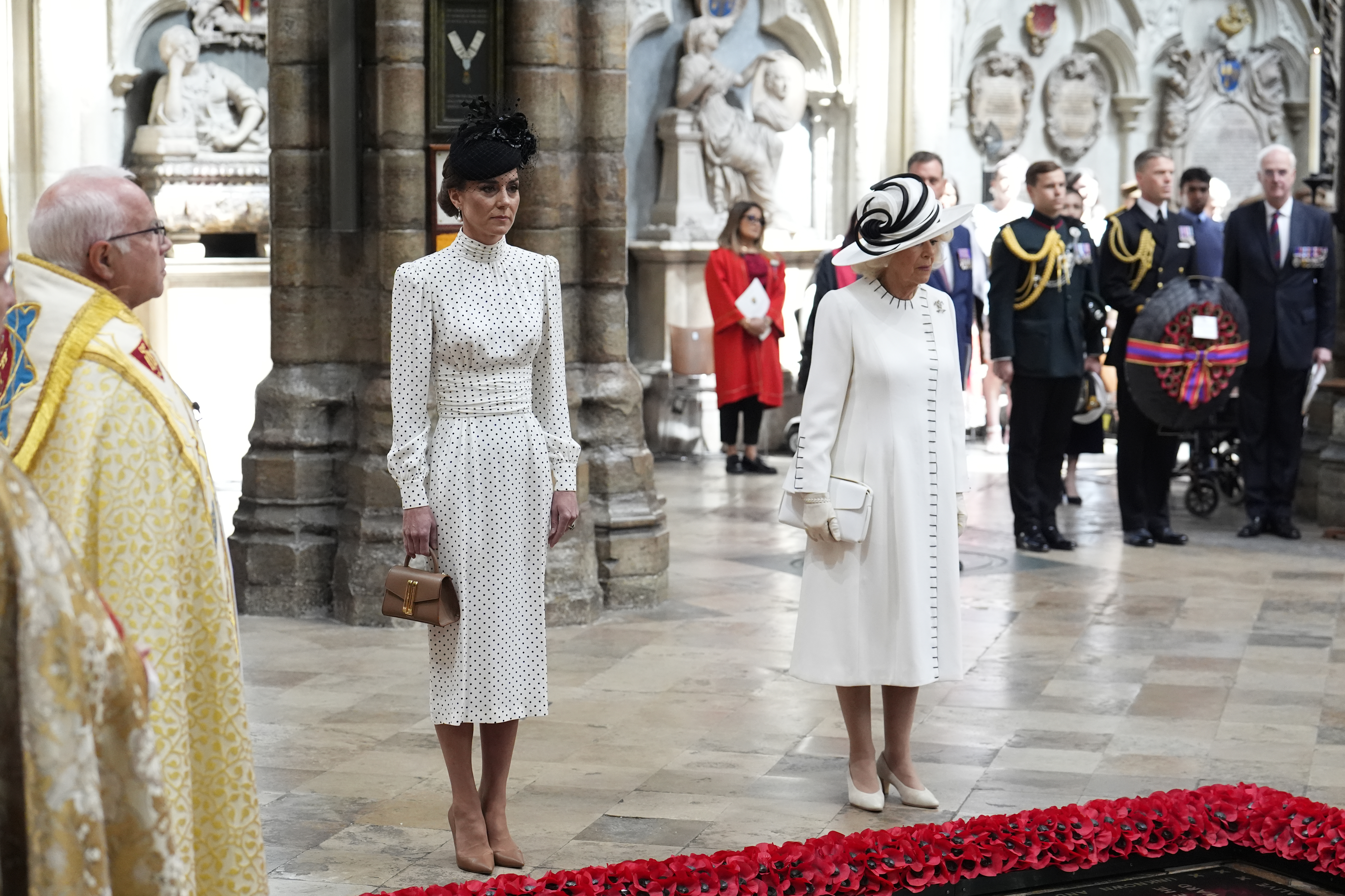 Kate Middleton and Queen Camilla wearing white dresses at Westminster Abbey