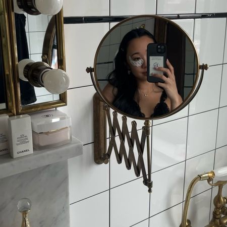 A woman wears skincare eye patches