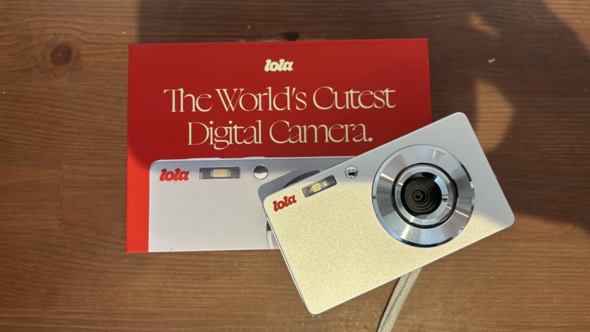 The Lola camera resting on top of its packaging